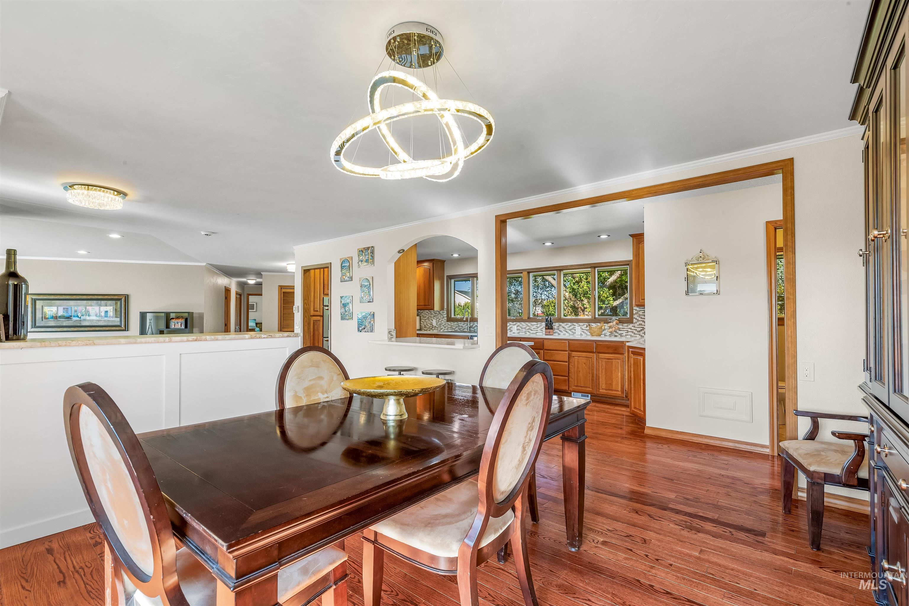Dining room featuring dark wood-style flooring and a chandelier