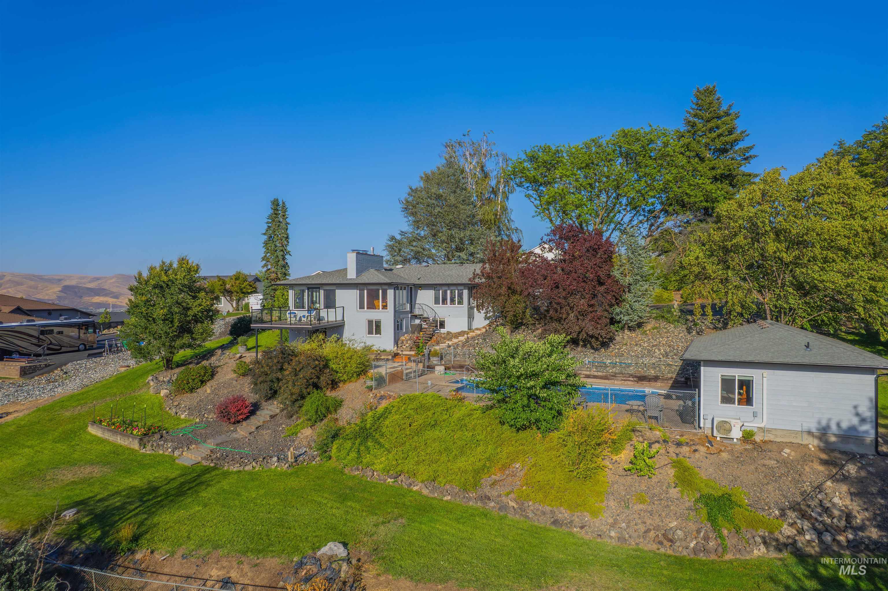 View of front of property with stairs and a chimney