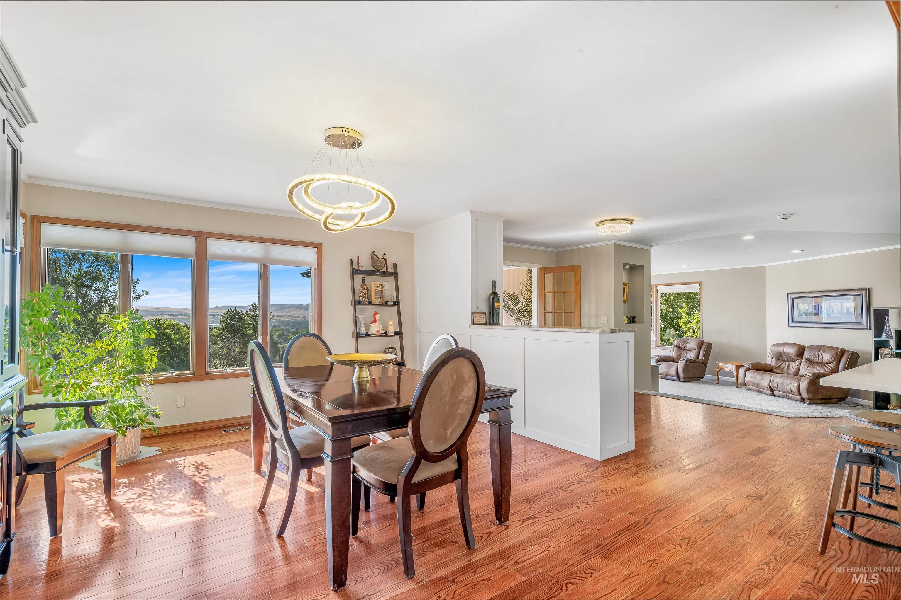 Dining room featuring light wood-style floors and crown molding