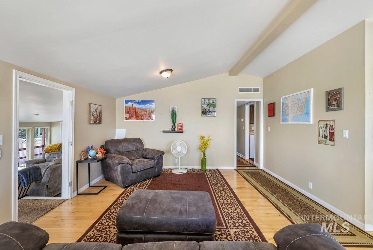 Living area with wood finished floors and baseboards