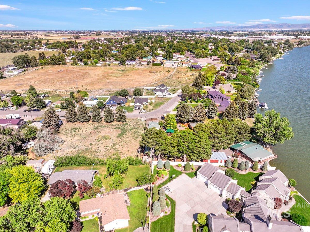 Aerial perspective of suburban area featuring a large body of water