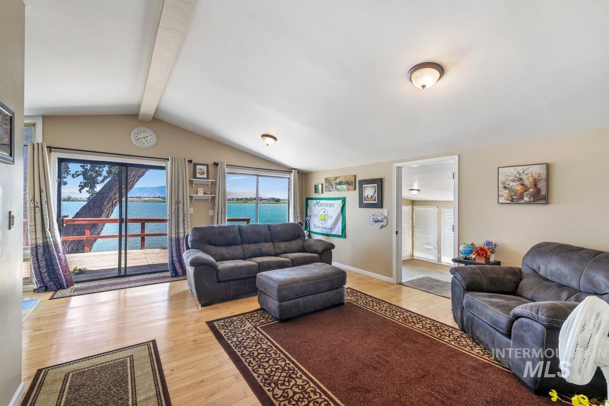 Living room with light wood-style flooring and a water view