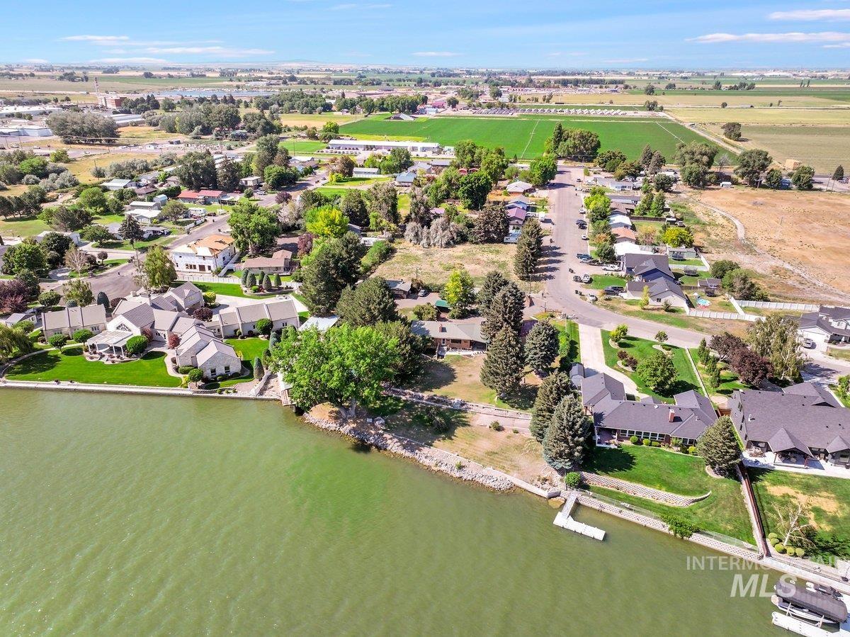 Aerial view of residential area featuring a nearby body of water