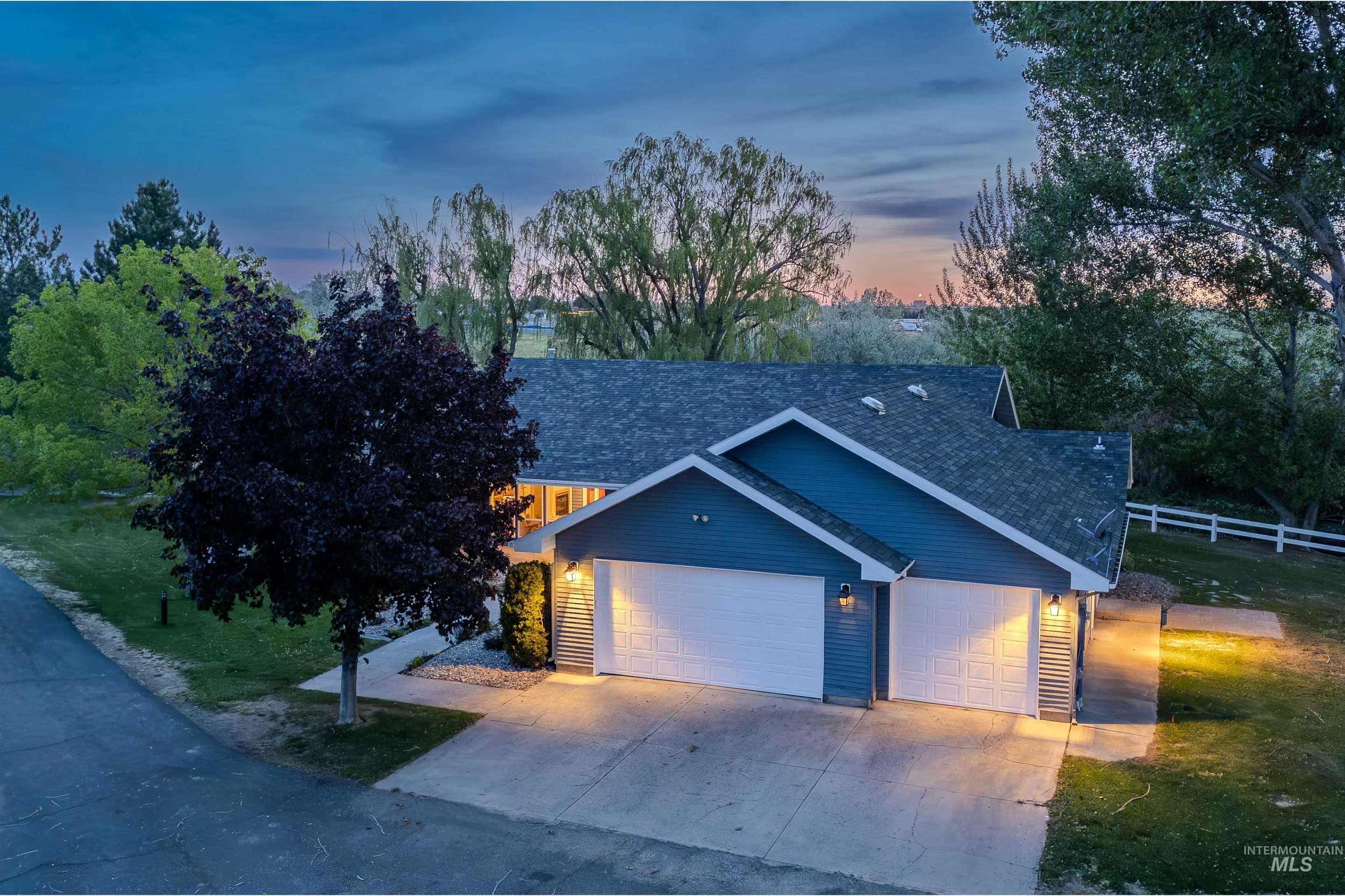 Blue siding exterior with a dark asphalt shingle roof