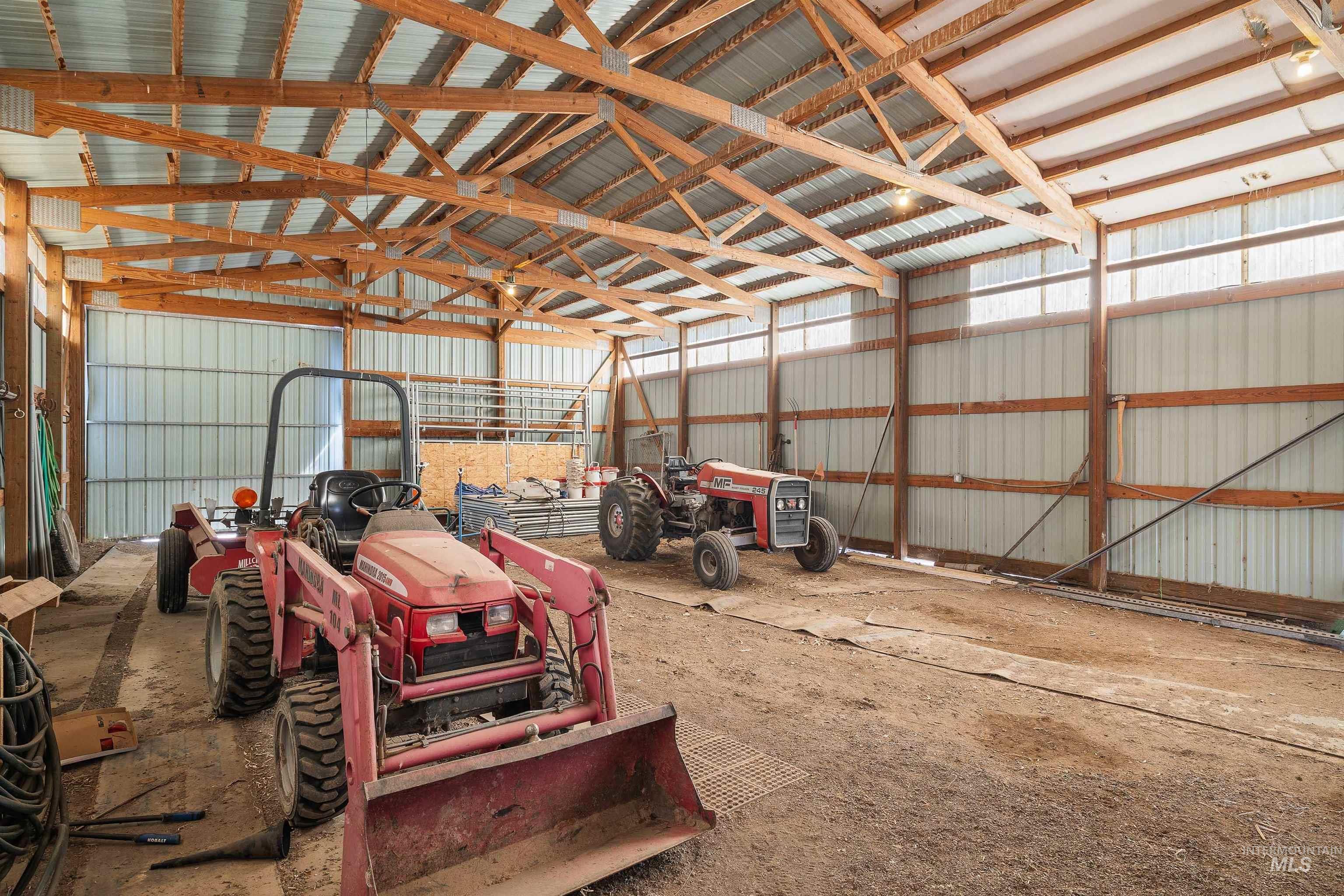 Spacious pole barn with exposed wood beam construction and corrugated metal roofing