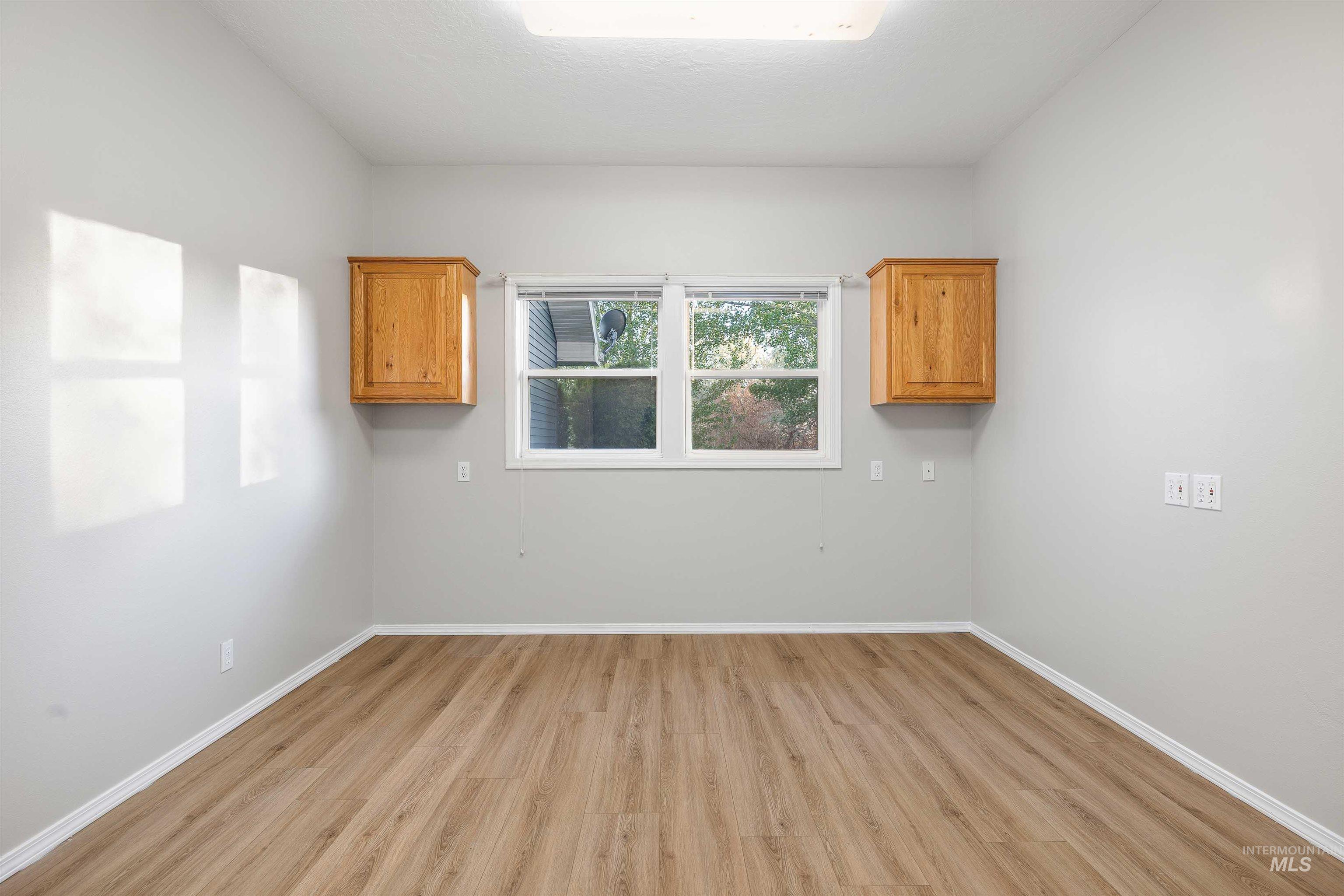Neutral wall tones complement wood-finish flooring