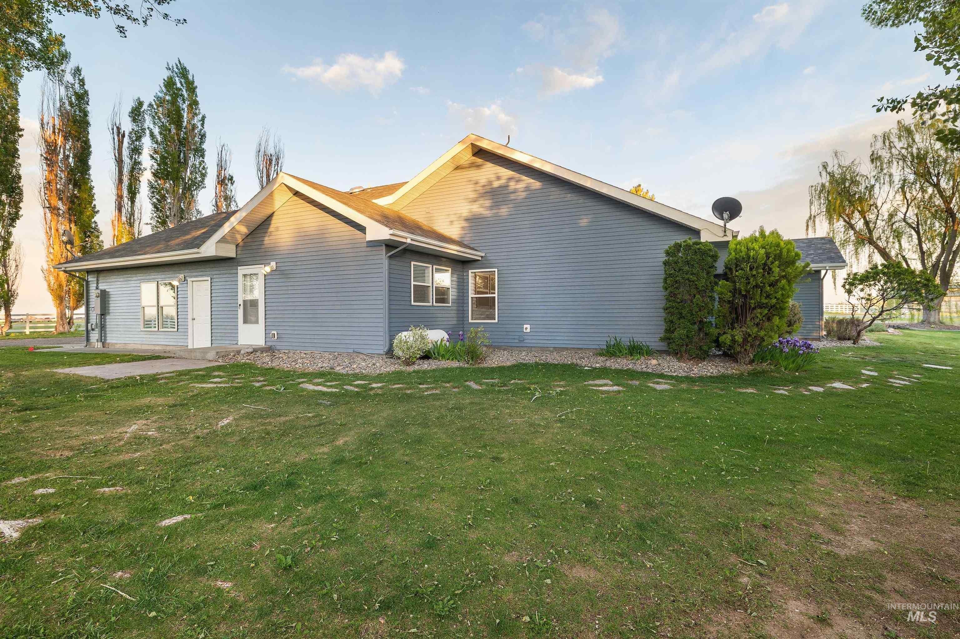 Expansive green lawn bordering the property, featuring mature trees and established landscaping
