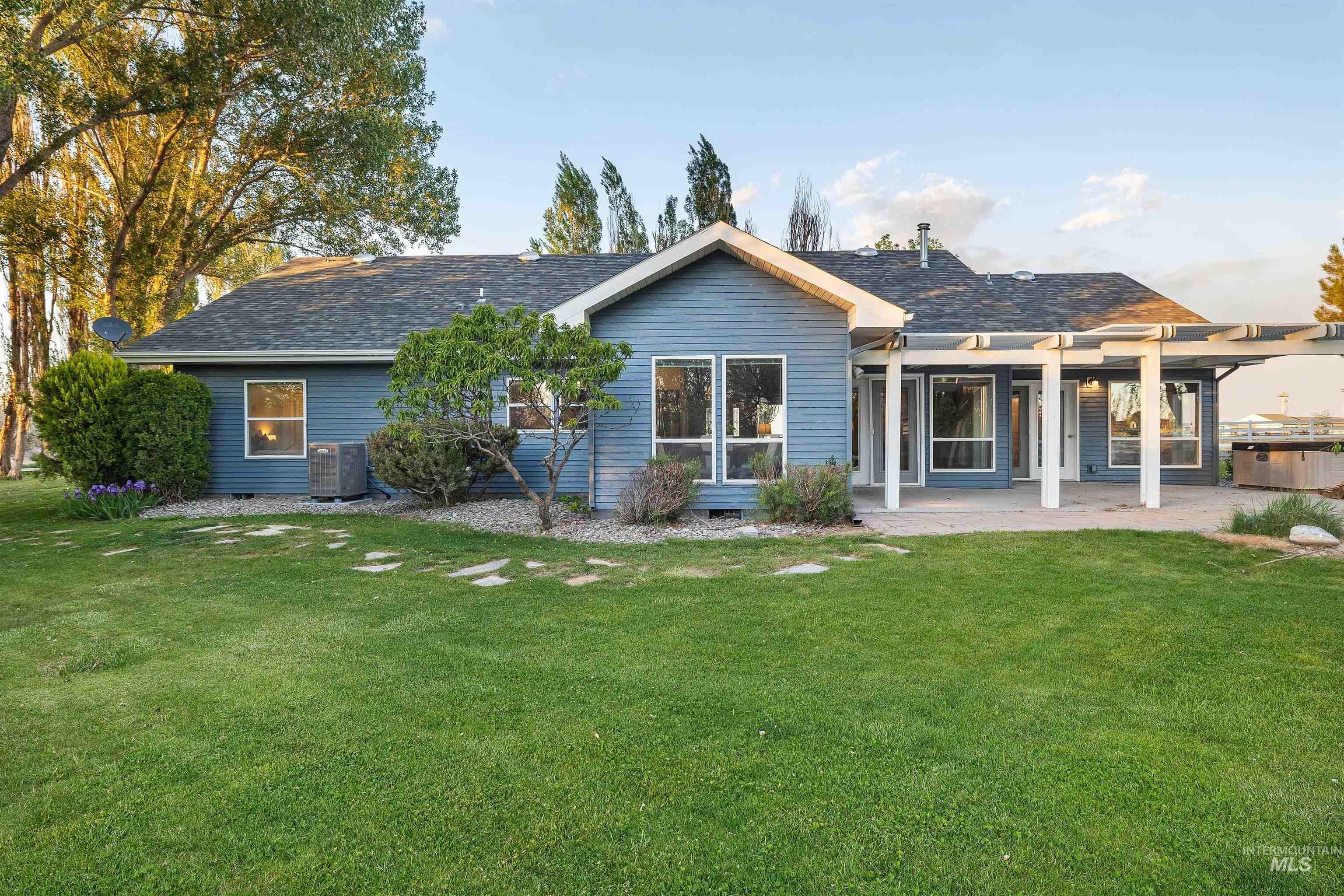 Expansive rear lawn with stepping stones