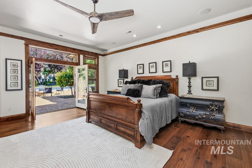 Spacious interior featuring wood-finish flooring, white walls, and a ceiling fan
