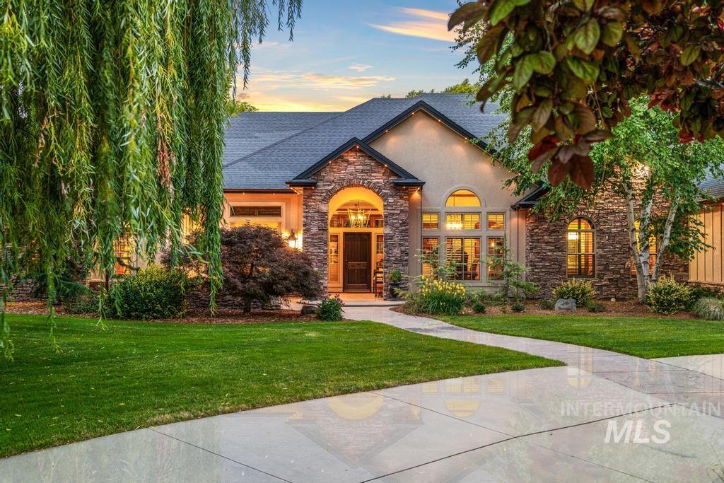 Stone and stucco exterior featuring a gabled roofline