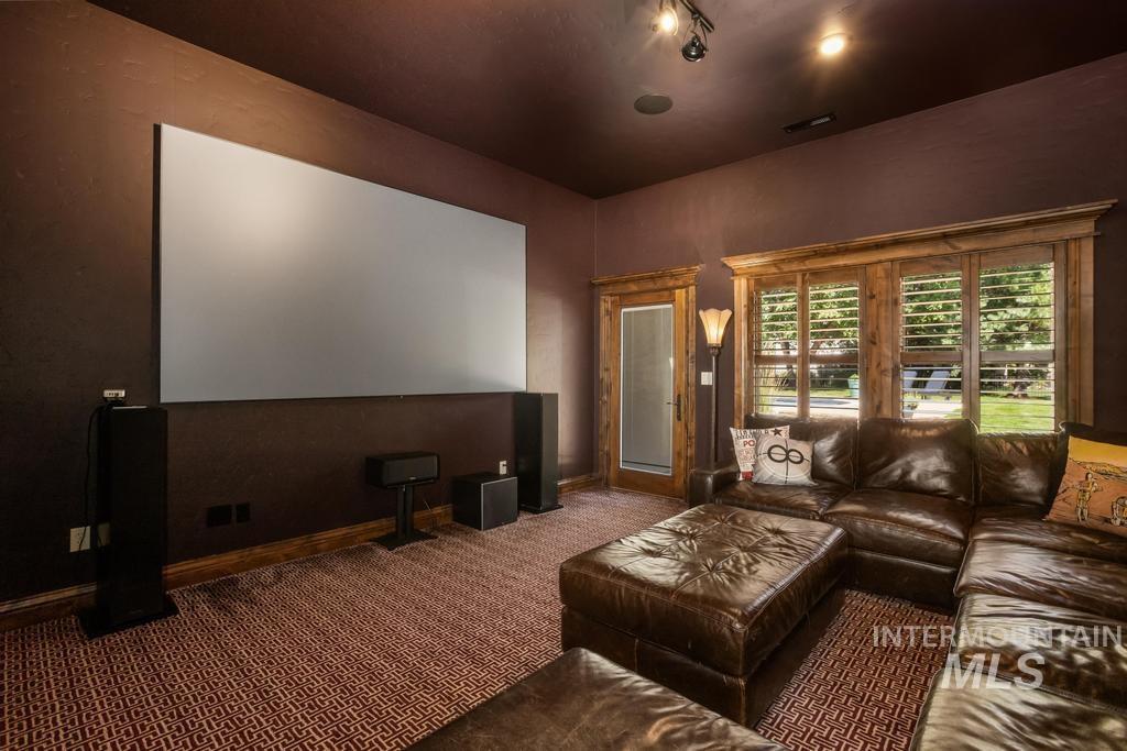 Dedicated media room featuring a large projection screen and built-in speakers