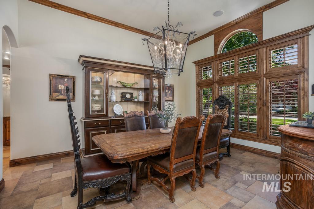 Dining area featuring extensive wood-frame windows with plantation shutters and an arched transom window