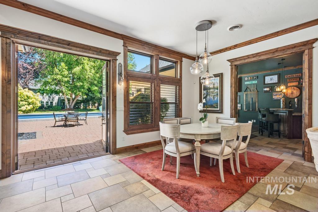Eat in Dining area with expansive views of paved patio and pool area