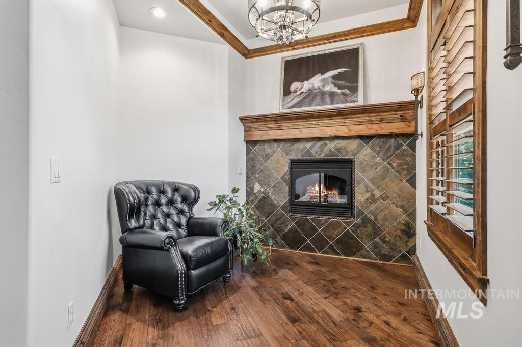 Fireplace featuring a stone tile surround and a wood mantel