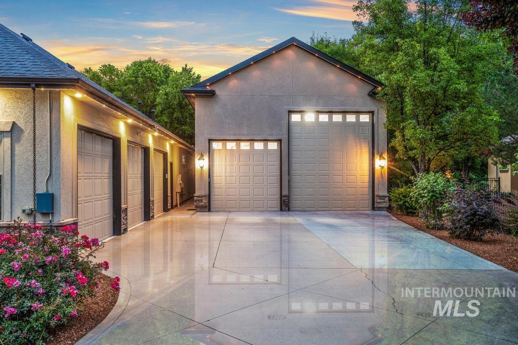 Expansive concrete driveway servicing multiple garage doors