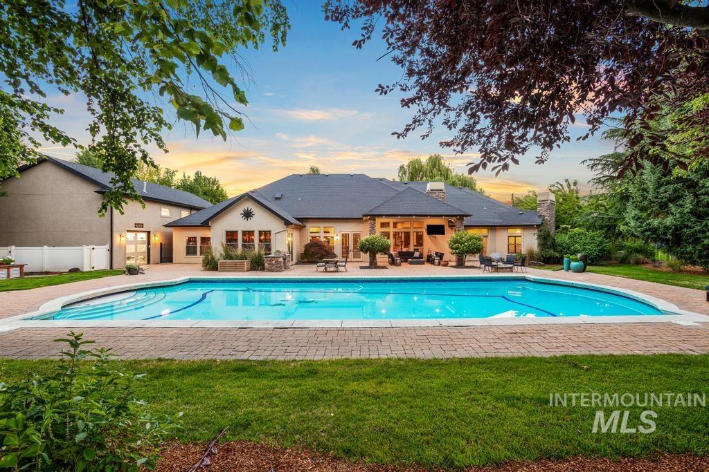 Expansive swimming pool with a brick paver surround
