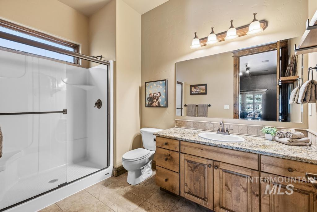 Bathroom featuring a shower with a sliding glass door and a transom window