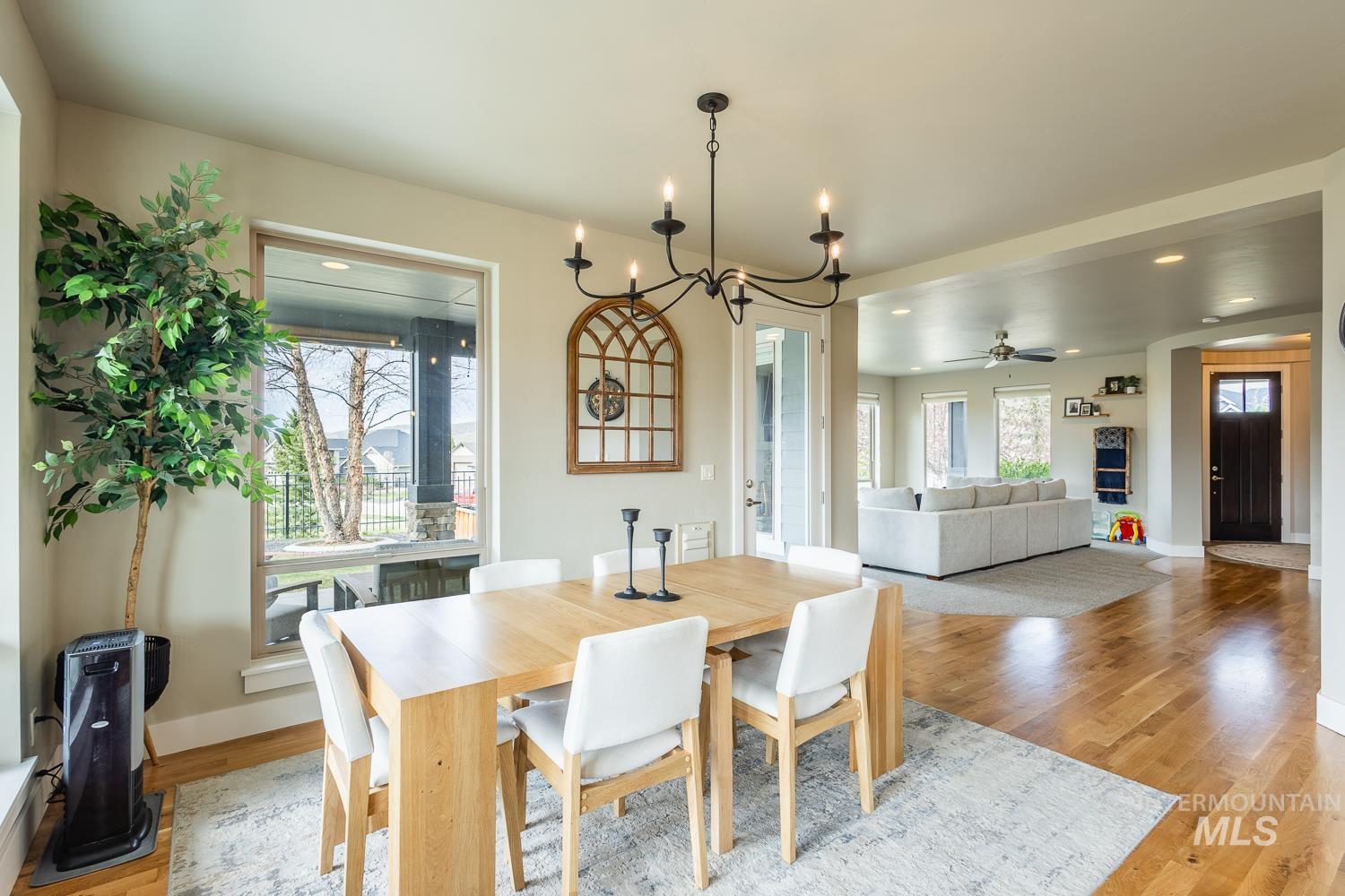 Dining space featuring suspended lighting, light wood-type flooring, and ceiling fan