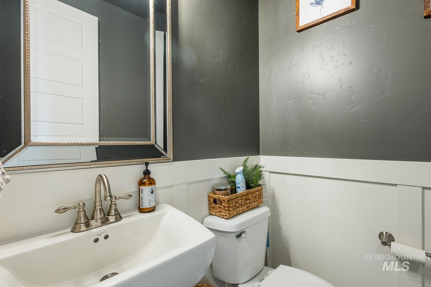 Bathroom featuring a sink and wainscoting