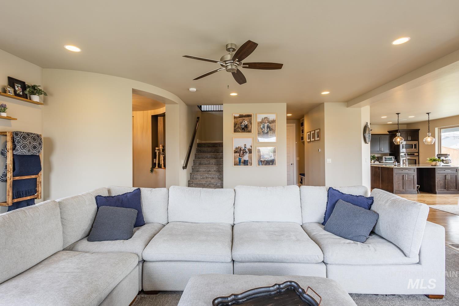Living room featuring ceiling fan and recessed lighting