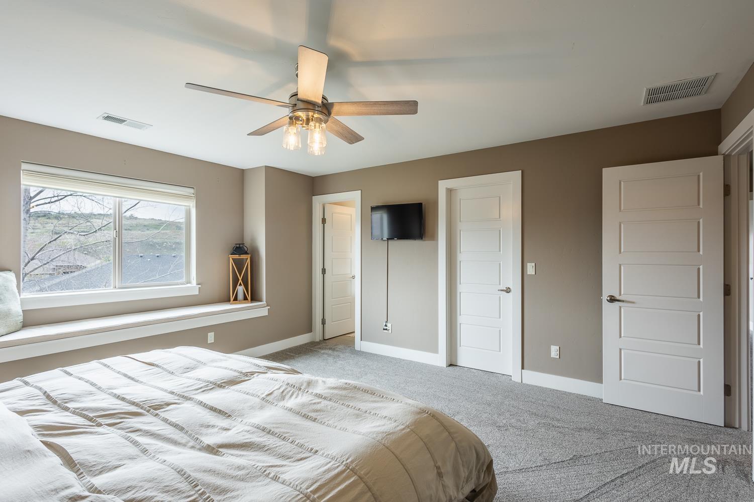 Carpeted bedroom with baseboards and ceiling fan