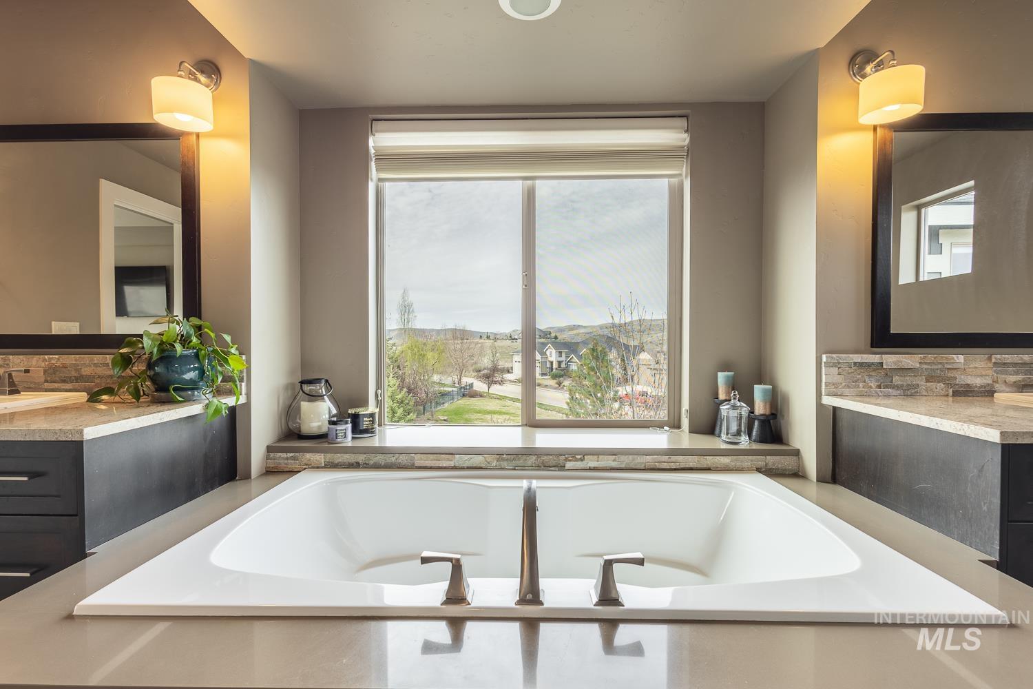Full bathroom with vanity, backsplash, and a garden tub