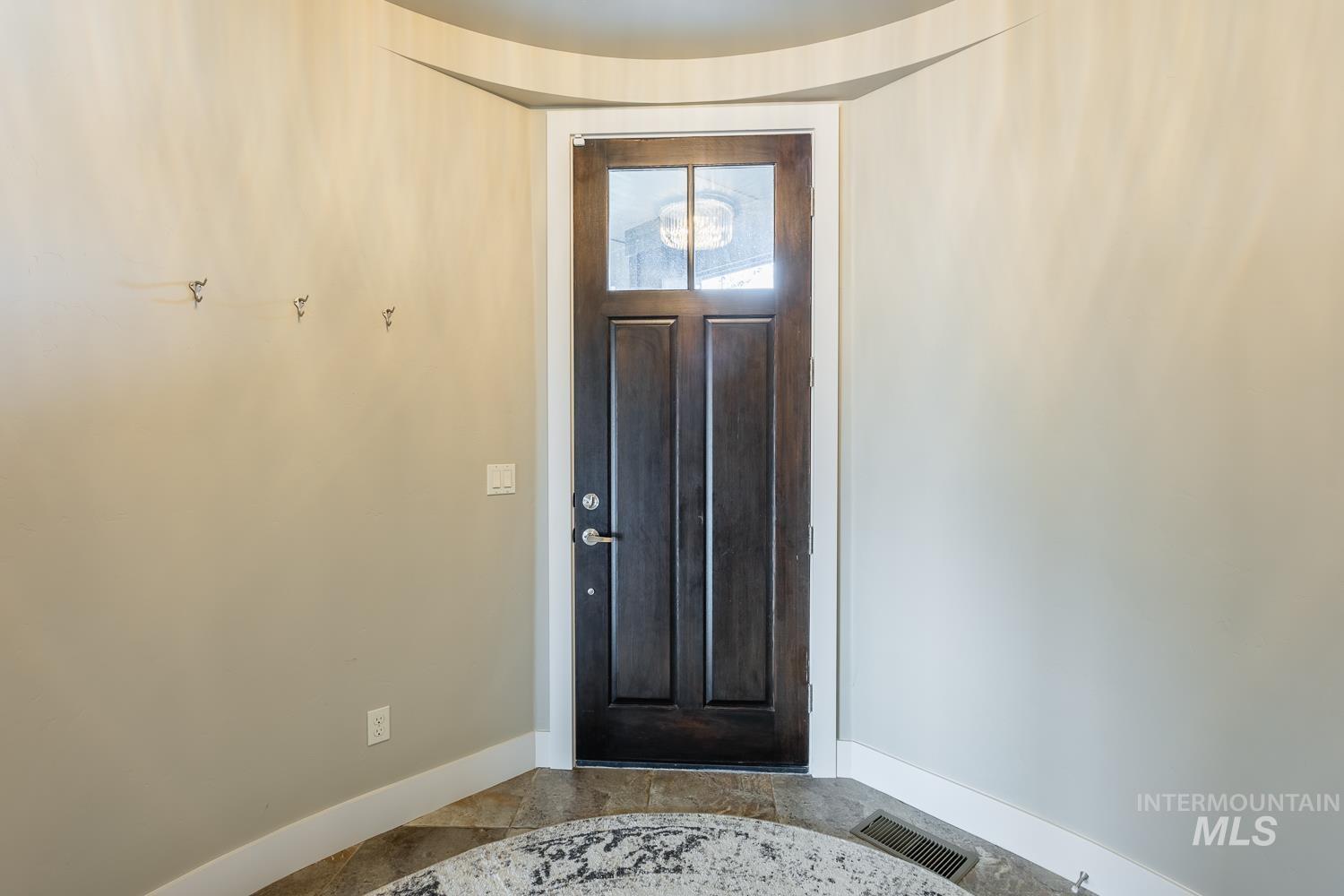 Foyer entrance with baseboards