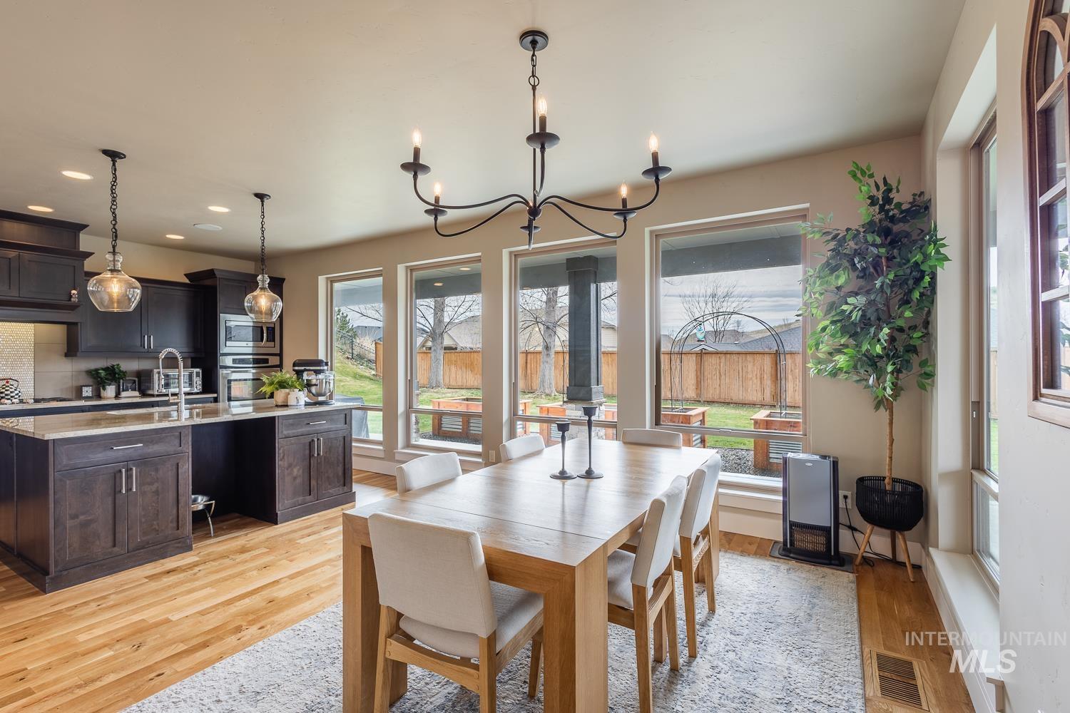 Dining area featuring suspended lighting and light wood finished floors