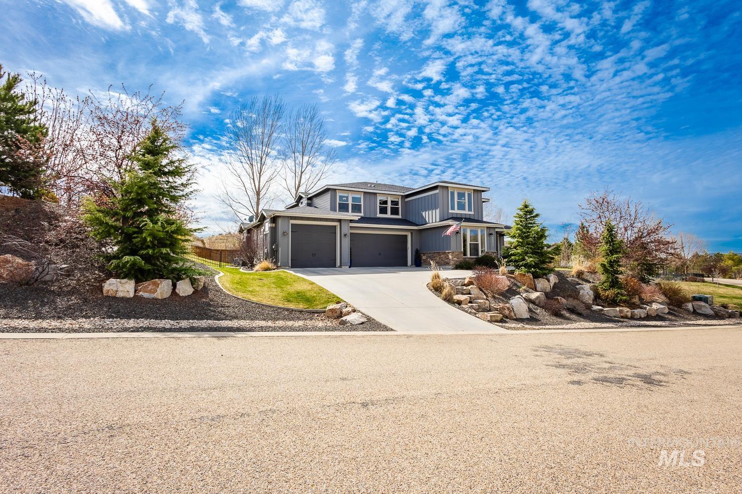 View of front of property featuring concrete driveway, board and batten siding, and a garage