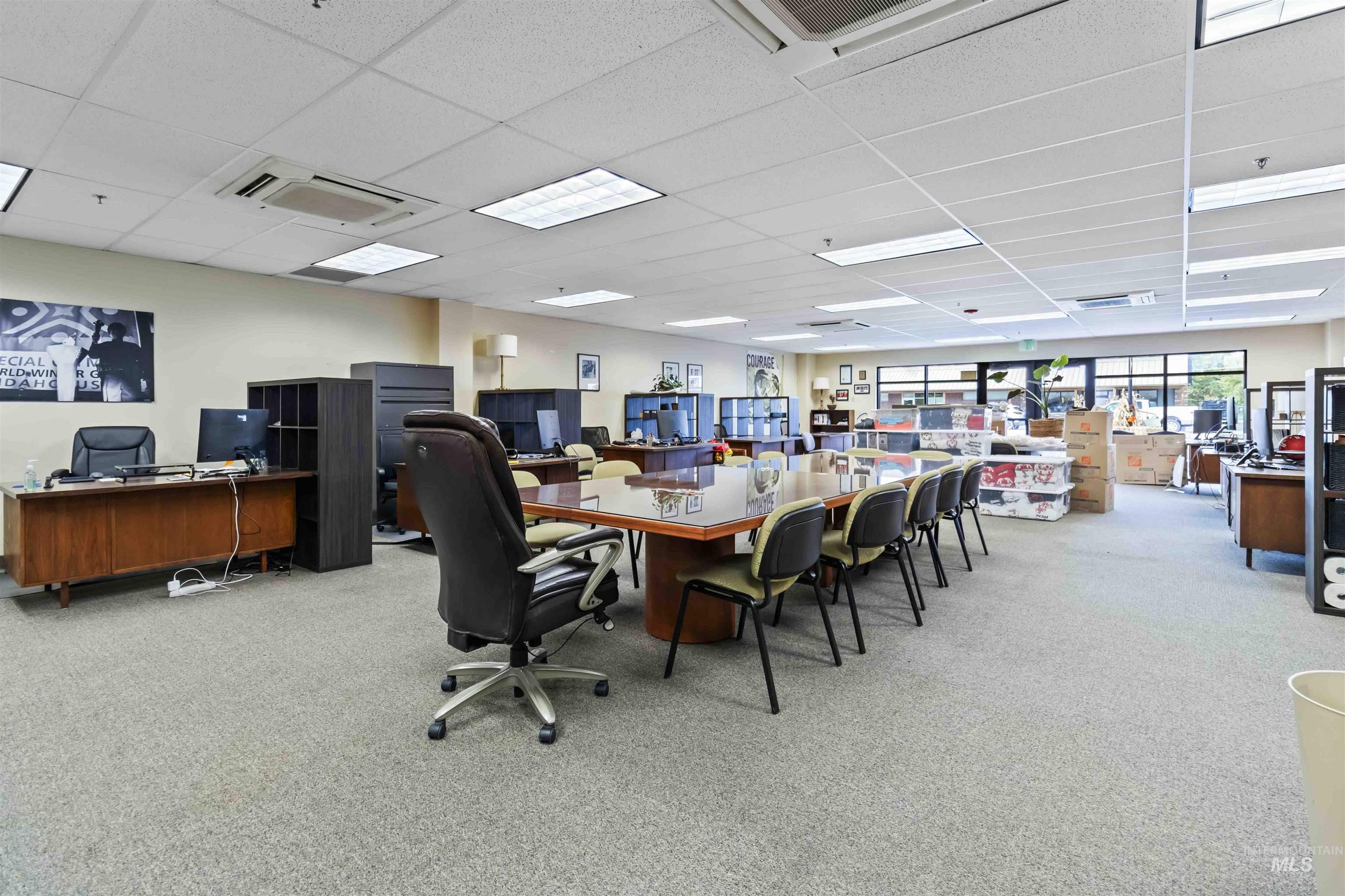 Office featuring a drop ceiling and cooling unit