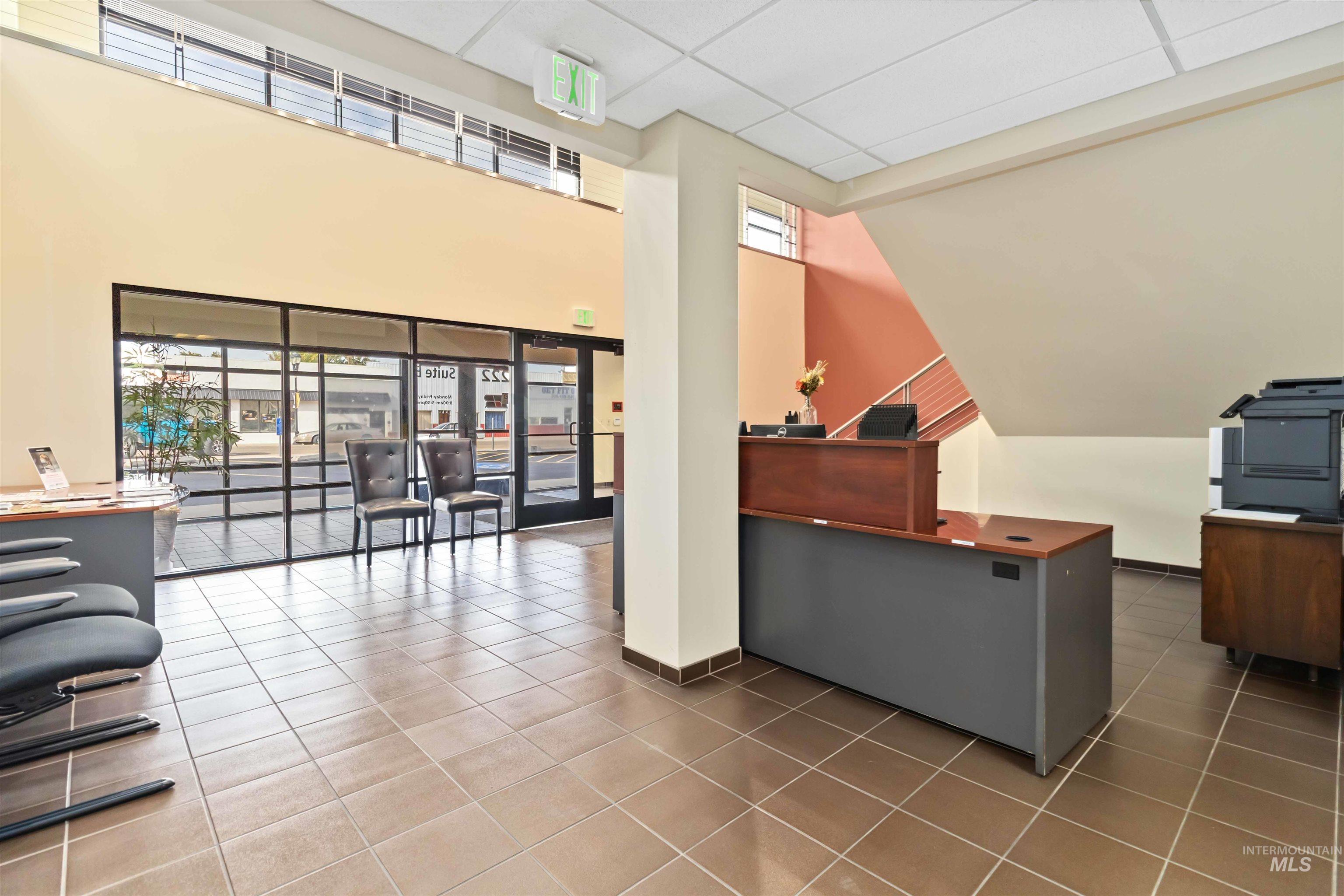 Reception with a drop ceiling and a high ceiling