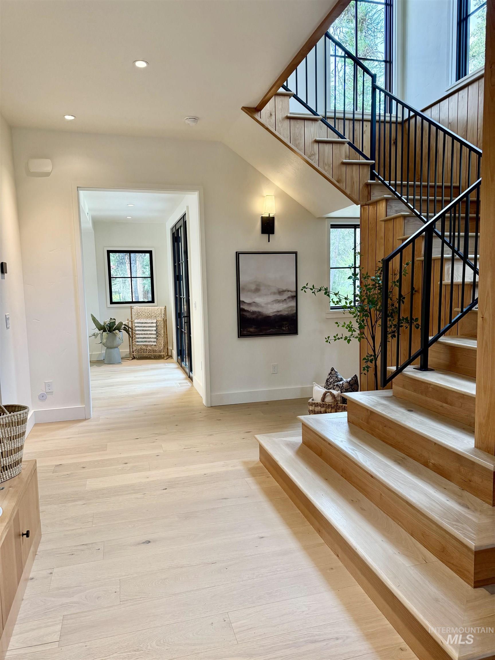 Stairway featuring wood-type flooring and recessed lighting
