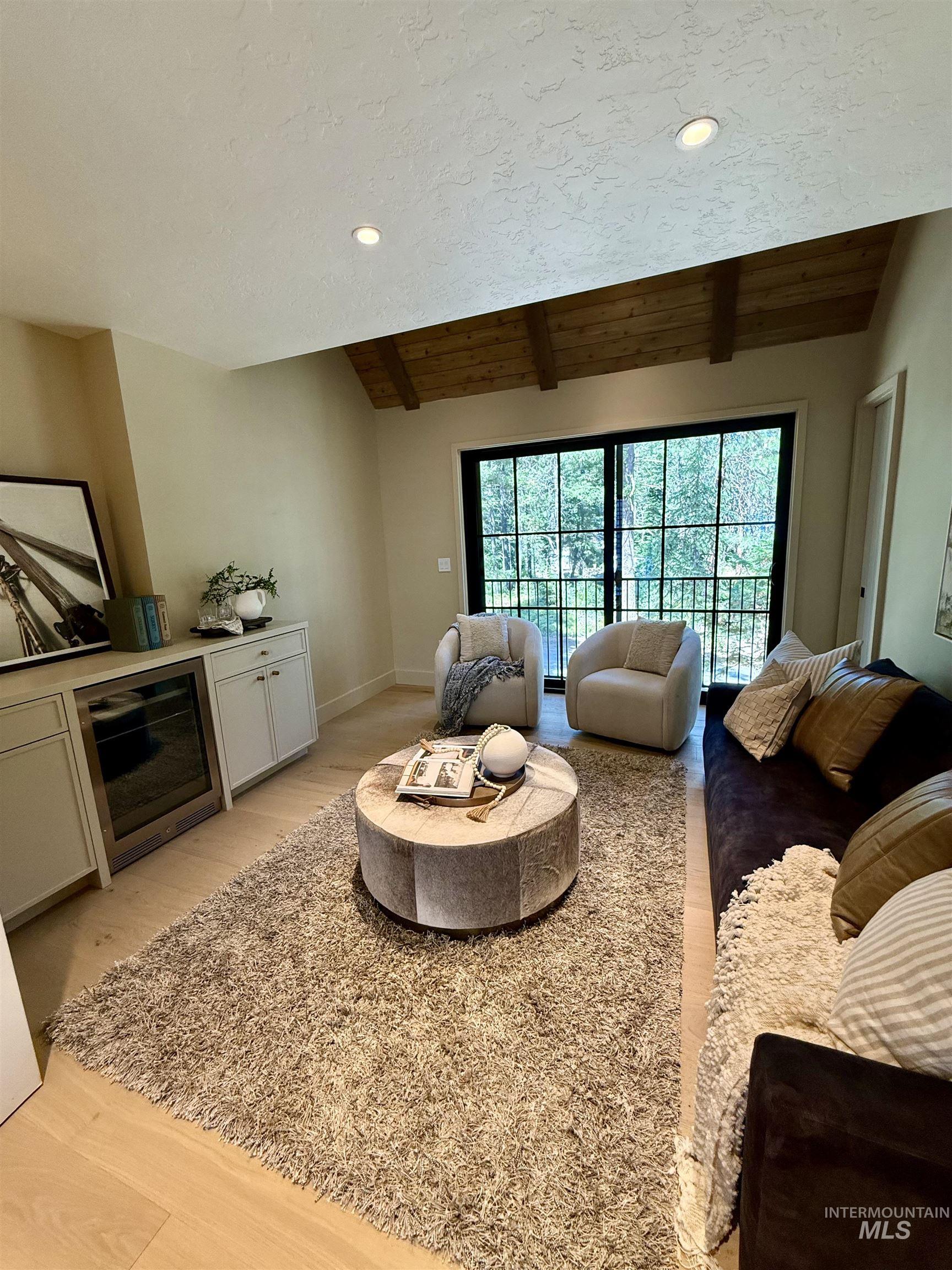Living area featuring light wood-type flooring, wood ceiling, and recessed lighting