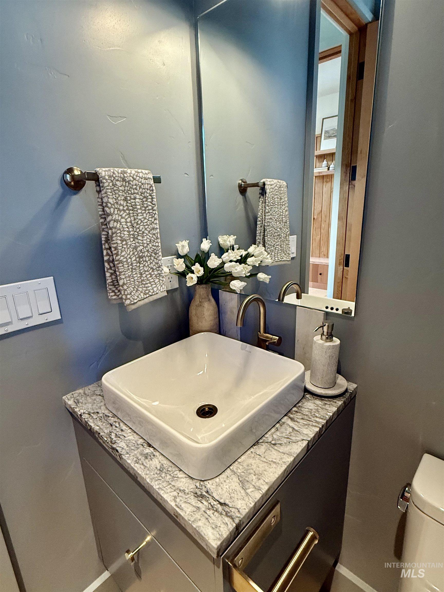 Half bath with vanity and toilet