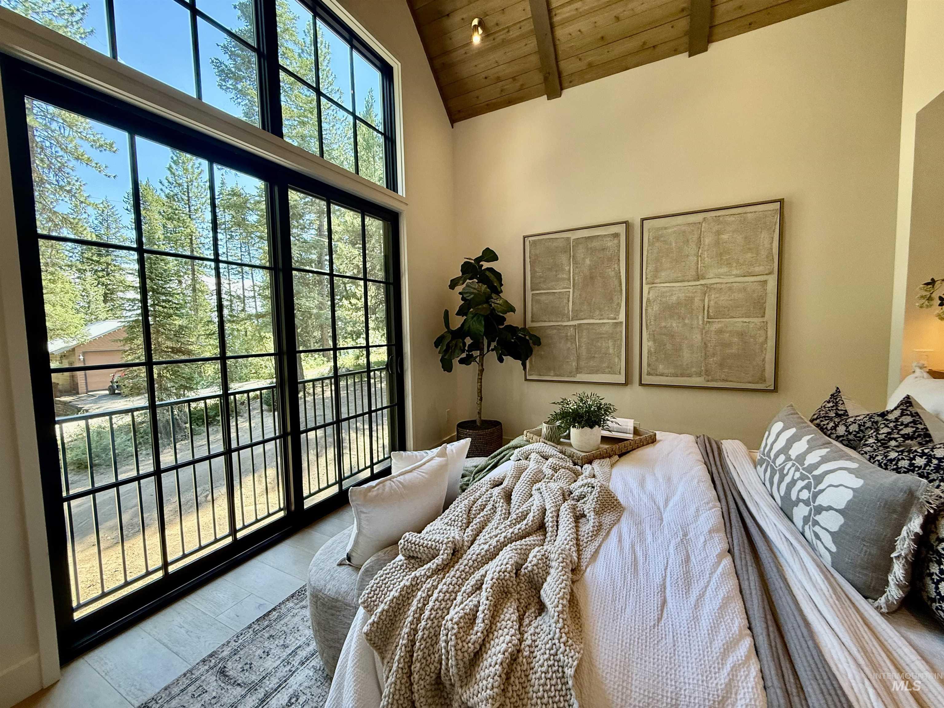 Bedroom featuring a wooden ceiling with exposed beams, access to exterior, high vaulted ceiling, and wood finished floors