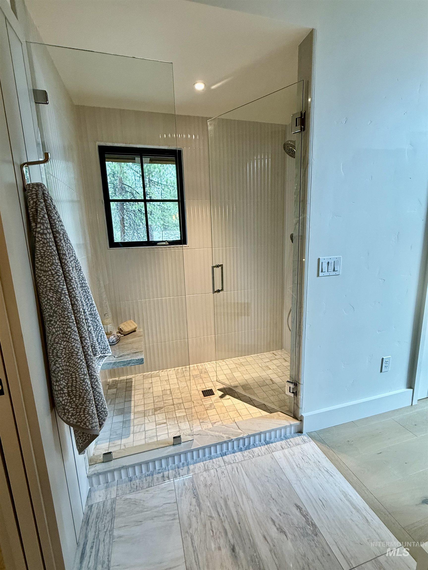 Full bath with a shower stall and recessed lighting