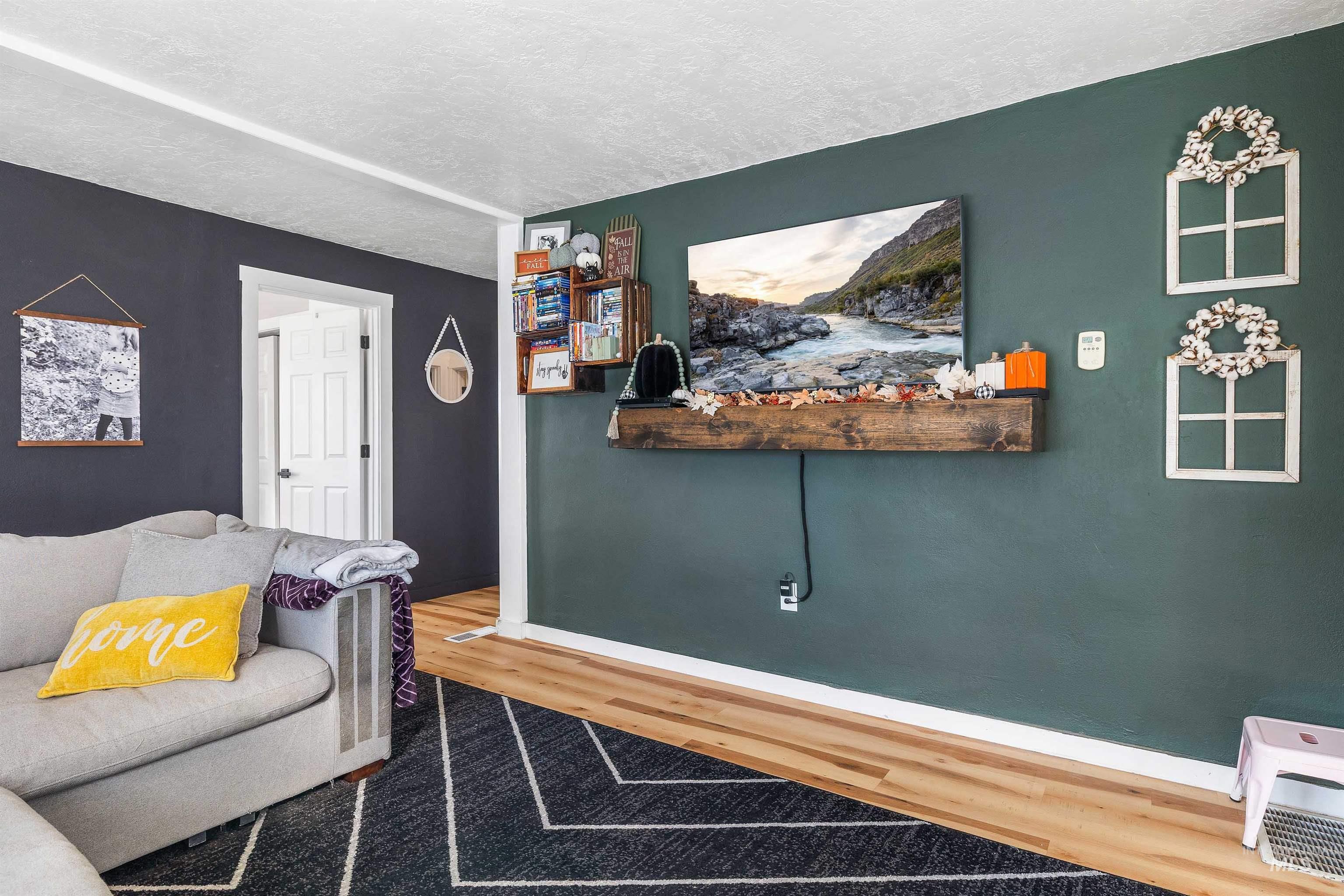 Living area featuring a textured ceiling and wood finished floors