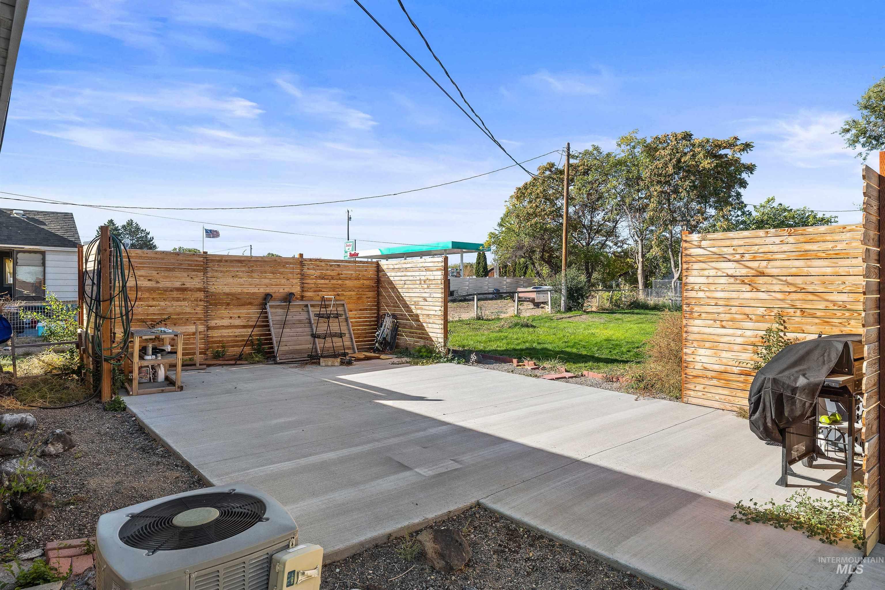 Fenced backyard with a grill and a patio area