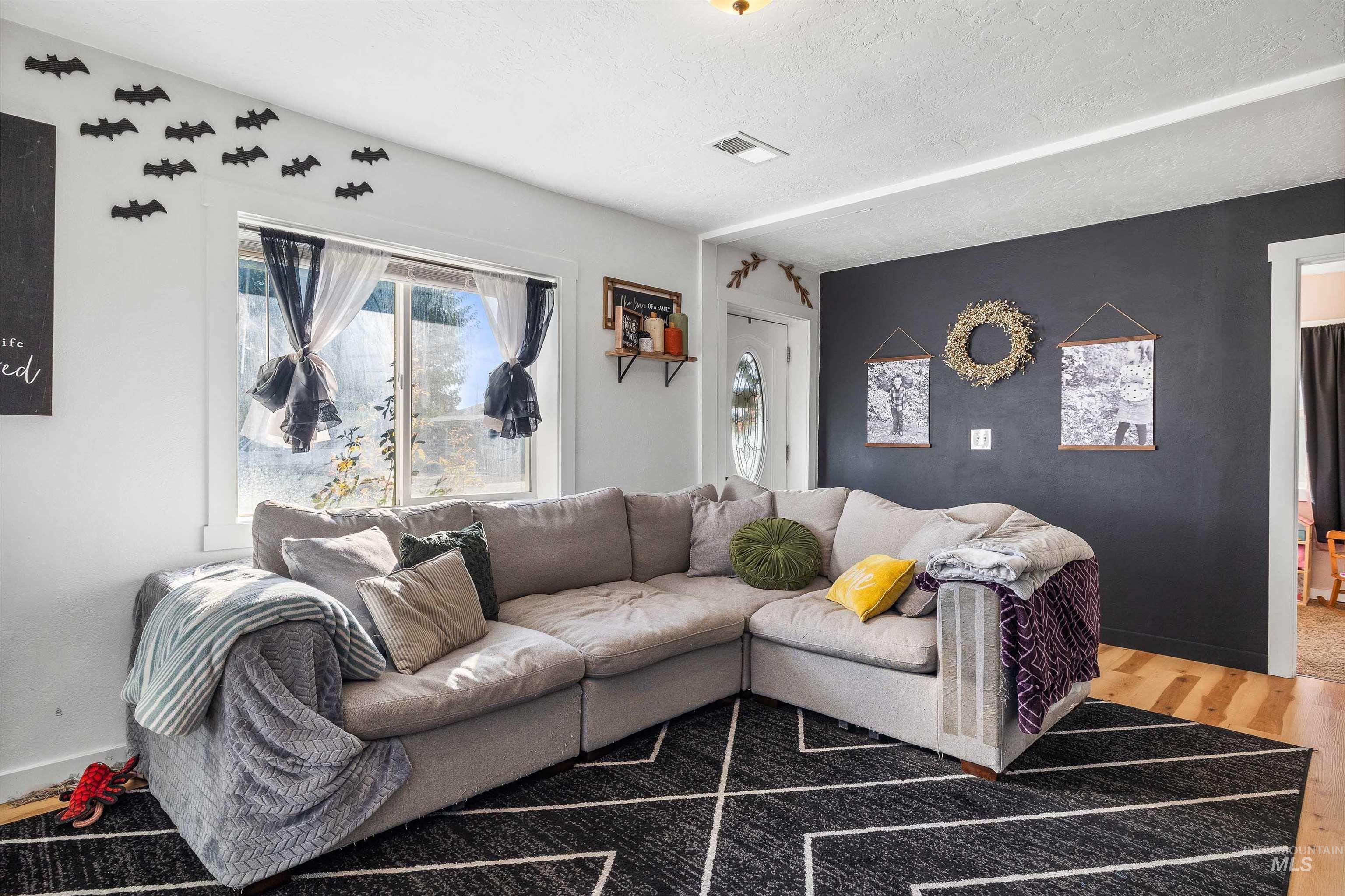 Living area with a textured ceiling and wood finished floors