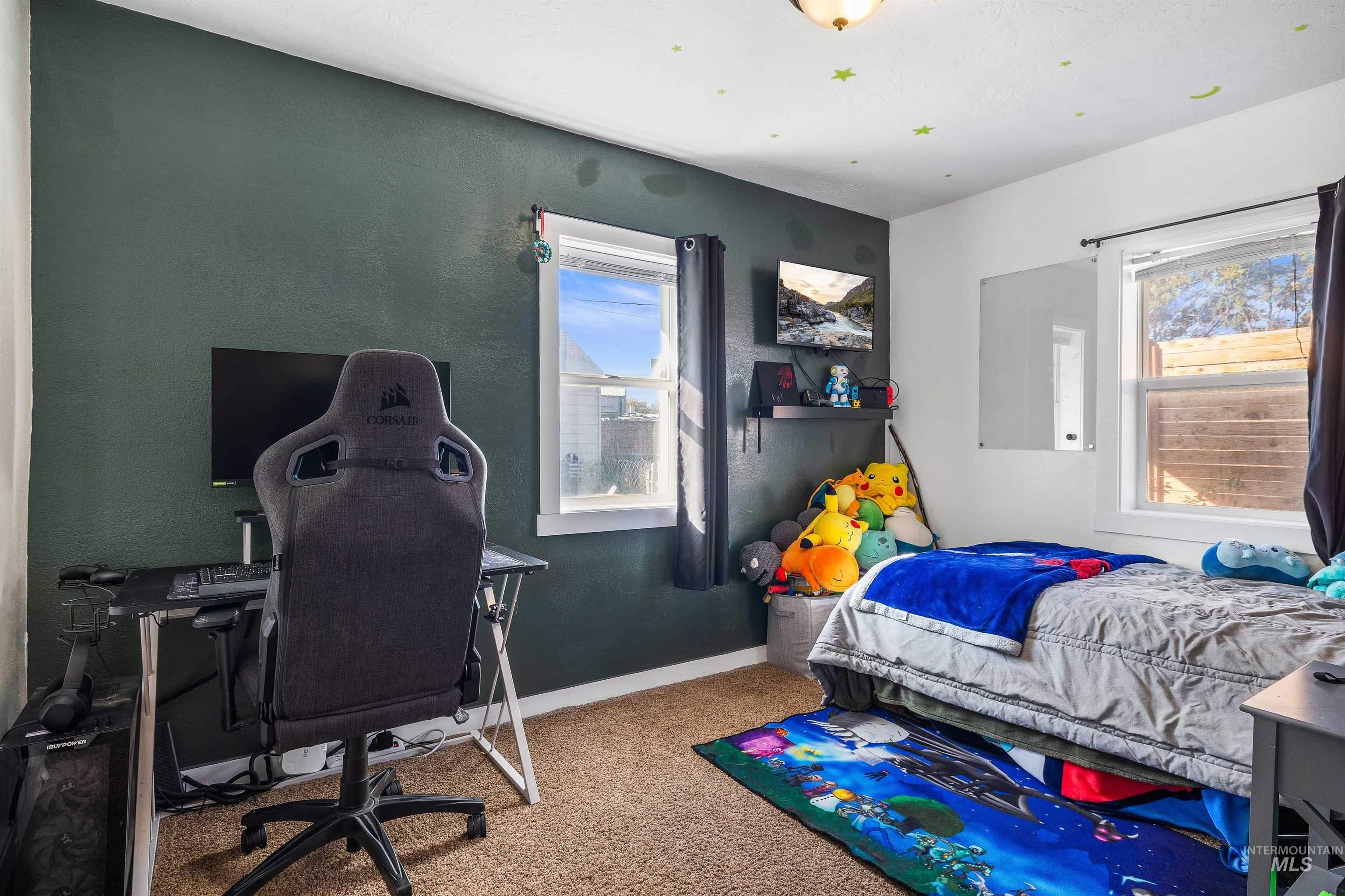 Bedroom featuring carpet flooring and an office area