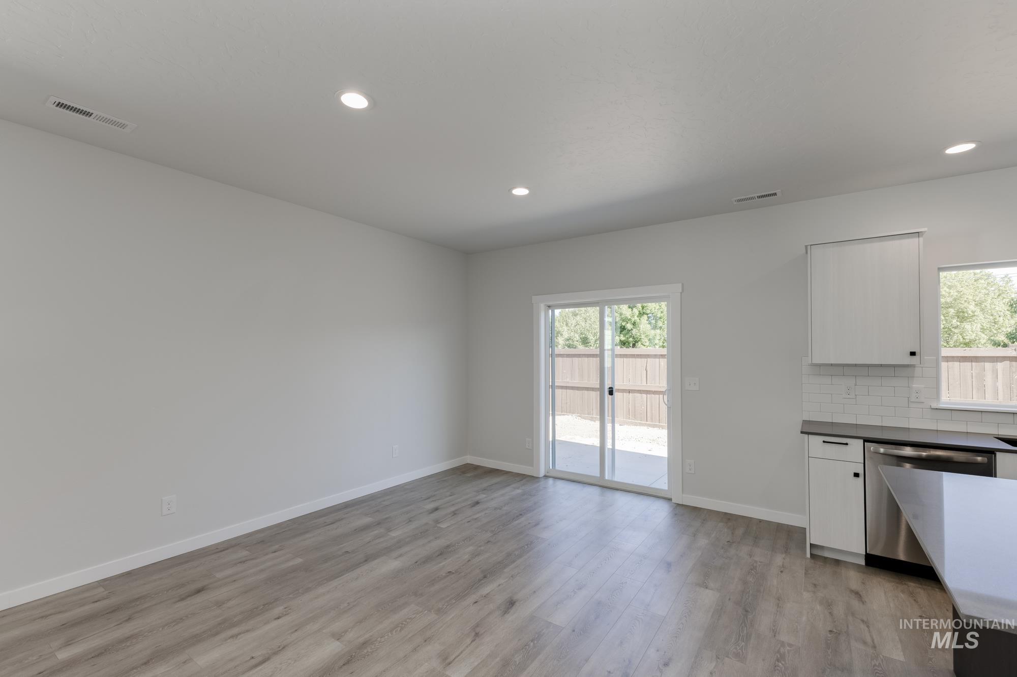 Unfurnished dining area featuring light wood-style flooring and recessed lighting