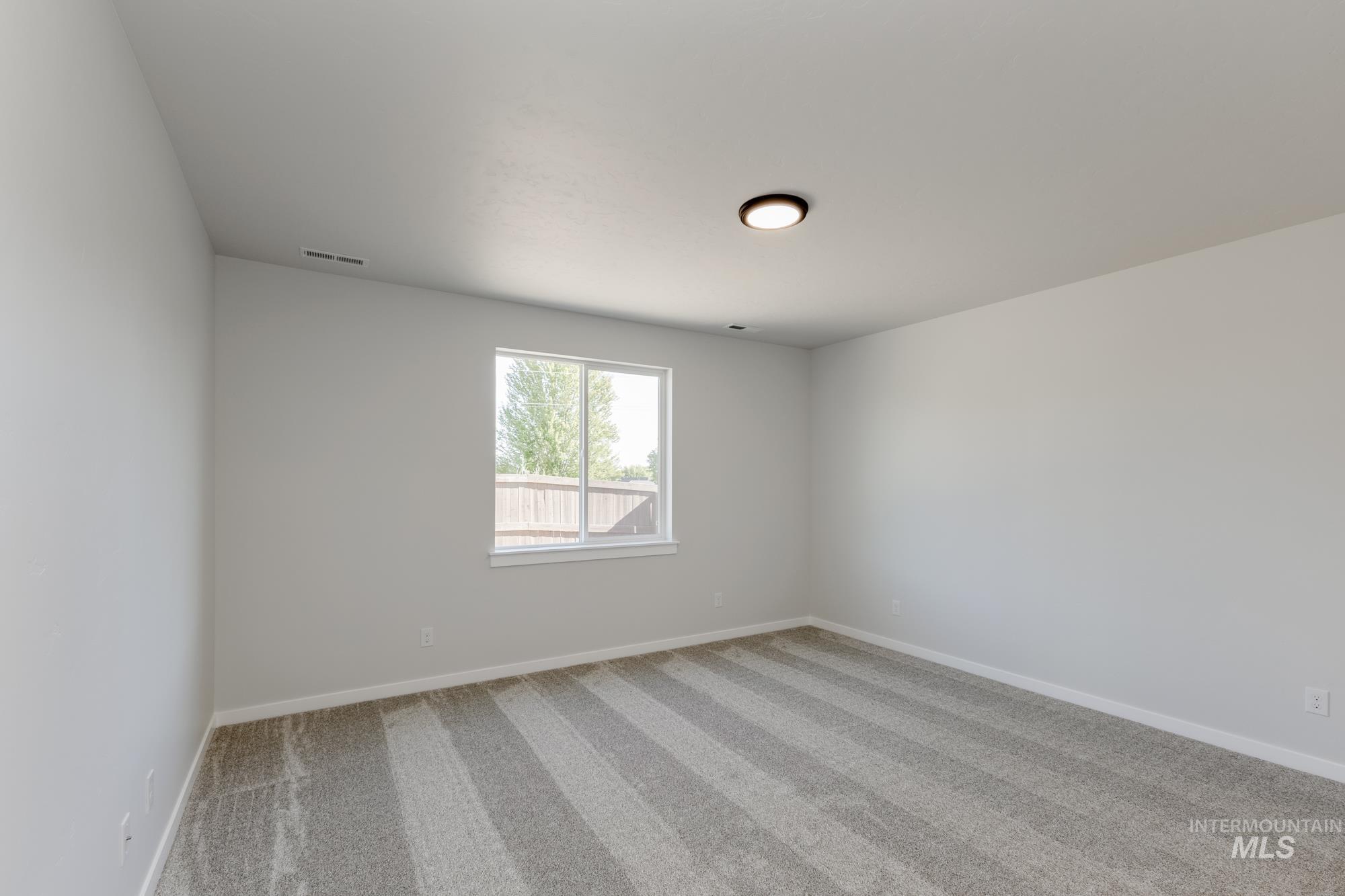 Unfurnished room with light carpet