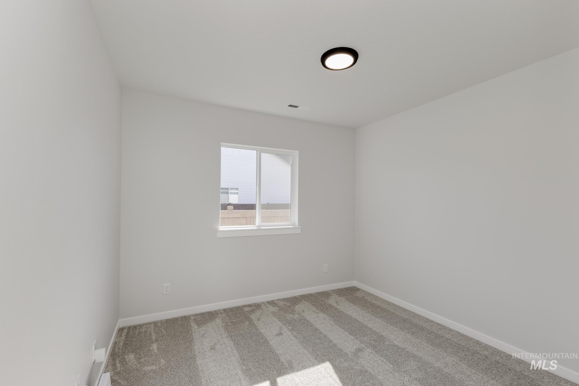 Empty room with carpet floors and baseboards