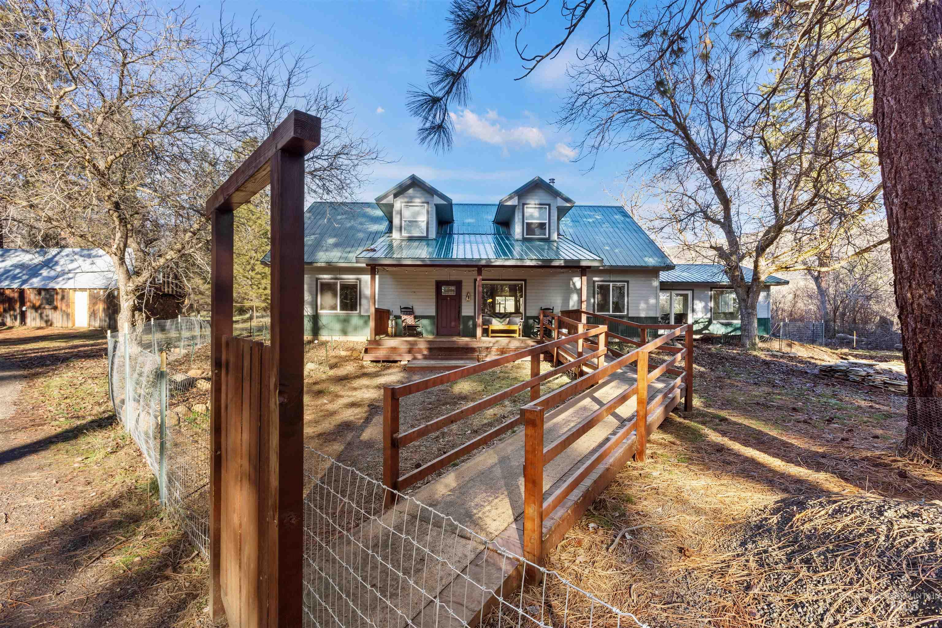 View of front of home featuring a metal roof and covered porch