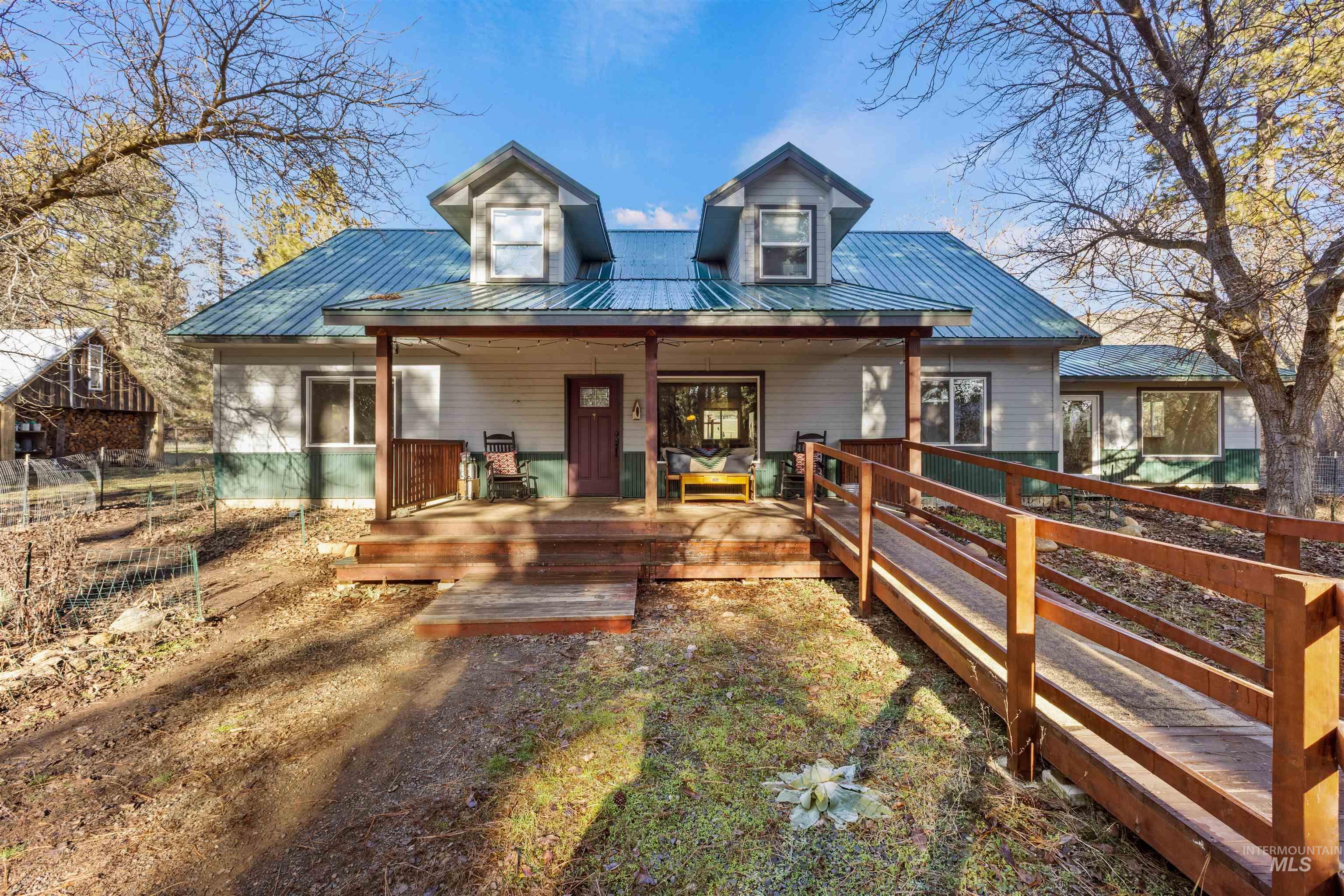 View of front of home featuring a metal roof and covered porch