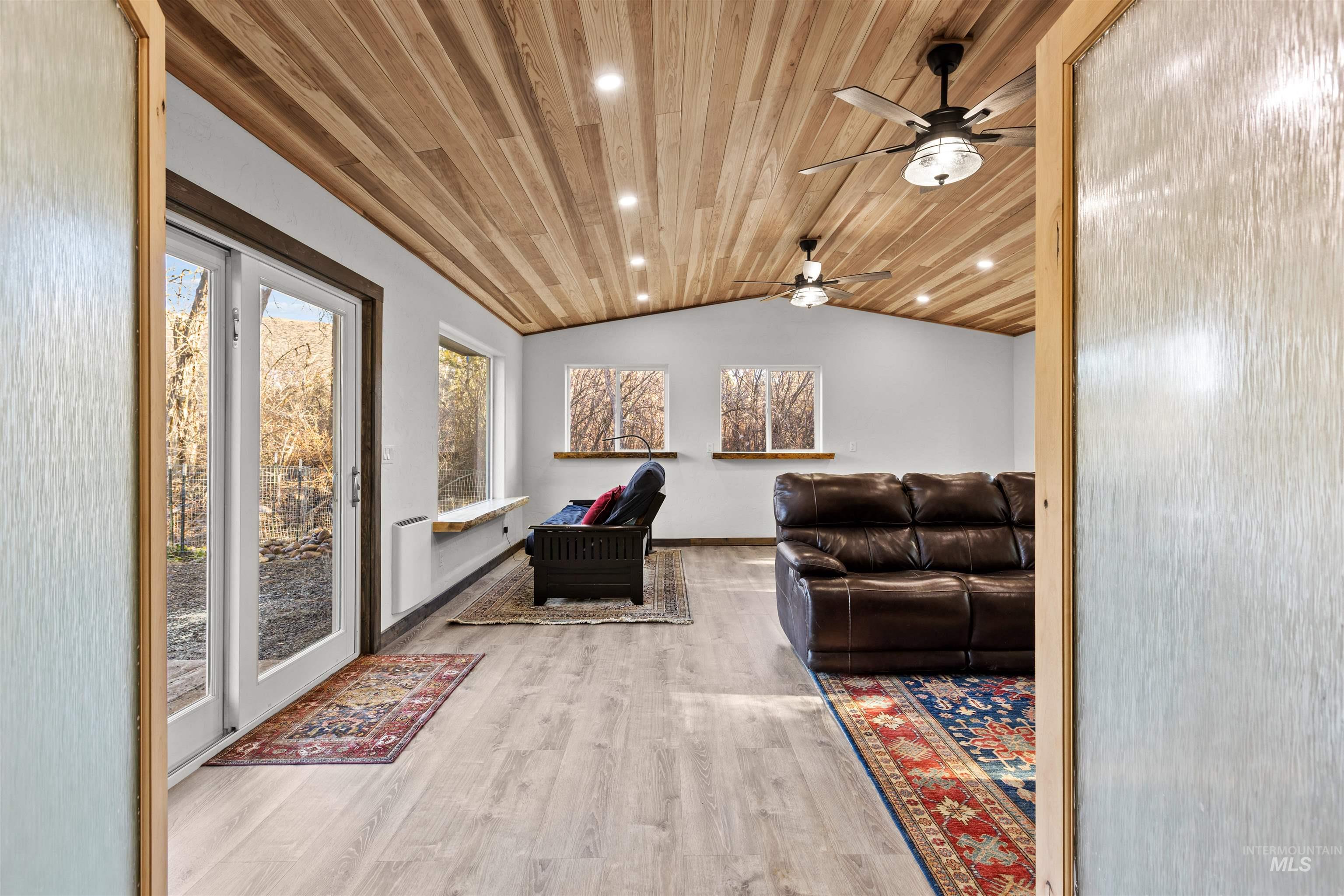 Living area with vaulted ceiling, light wood-type flooring, wood ceiling, and recessed lighting