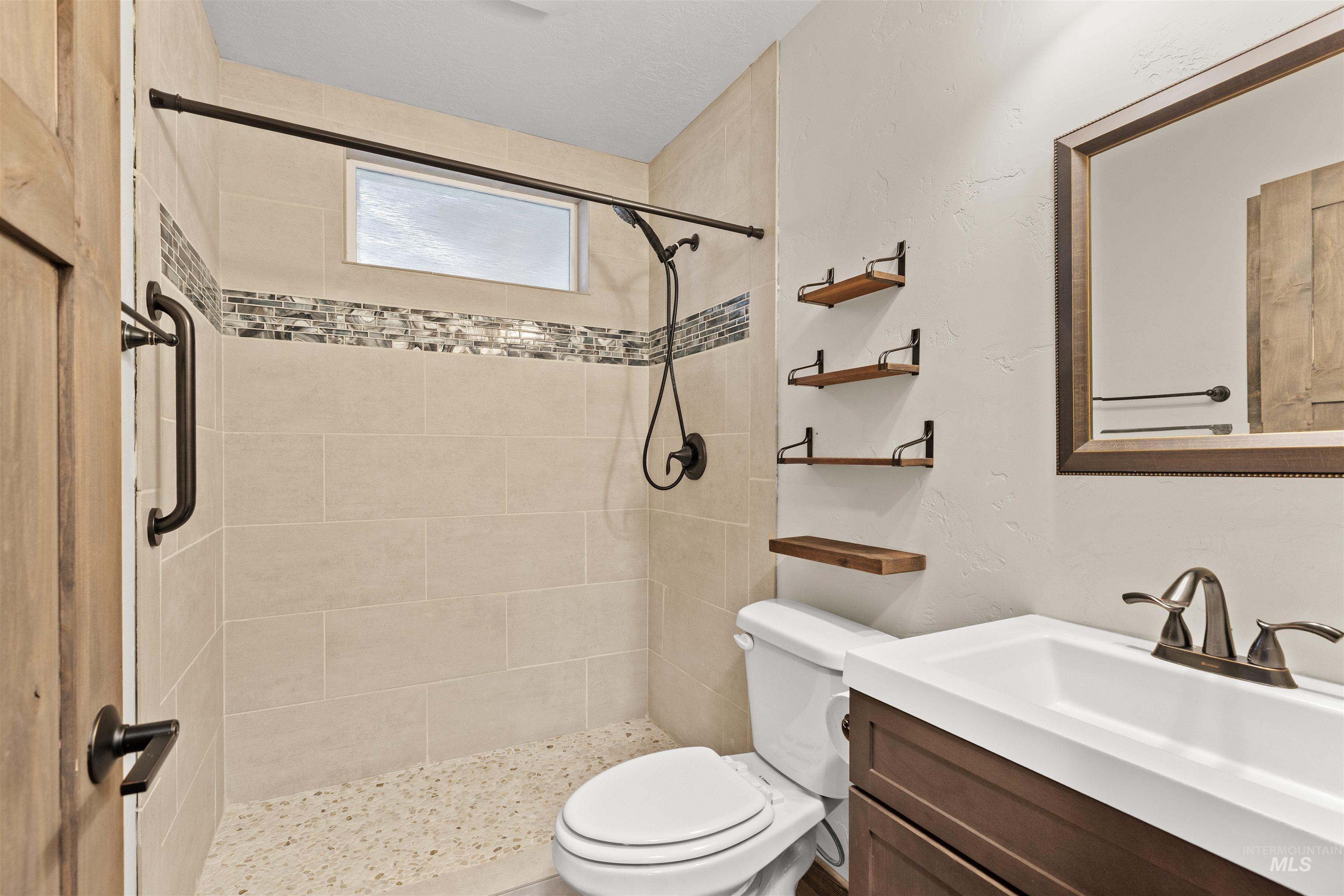 Full bath with vanity and a stall shower