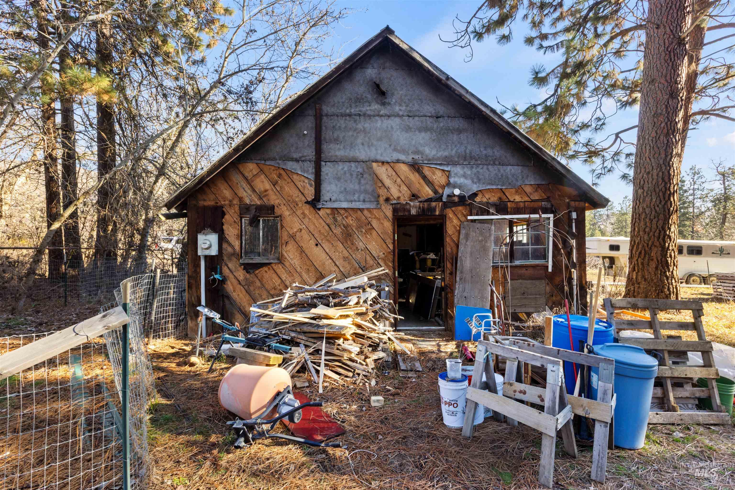 Rear view of property featuring an outbuilding
