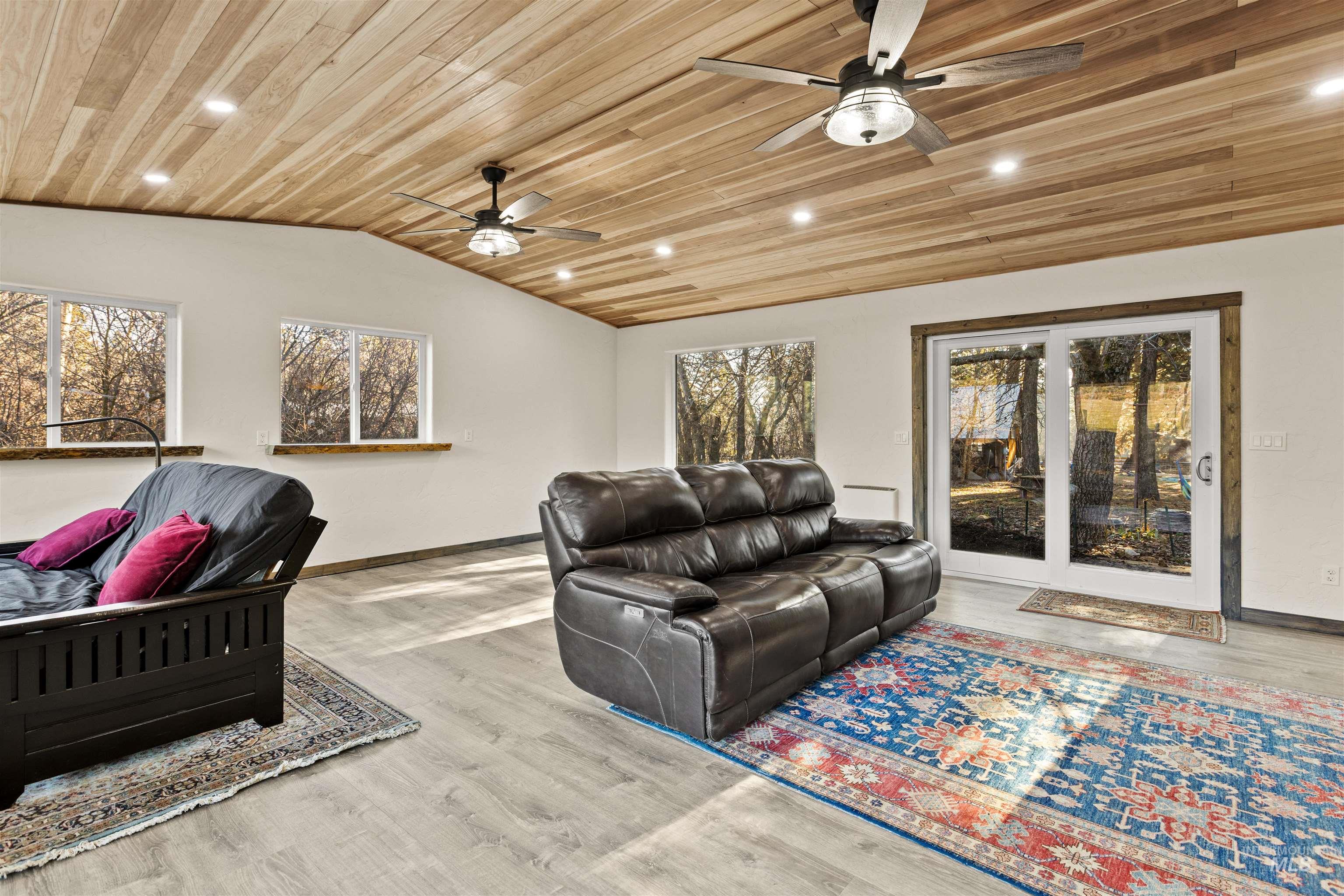 Sunroom featuring wooden ceiling, lofted ceiling, recessed lighting, and light wood-style floors