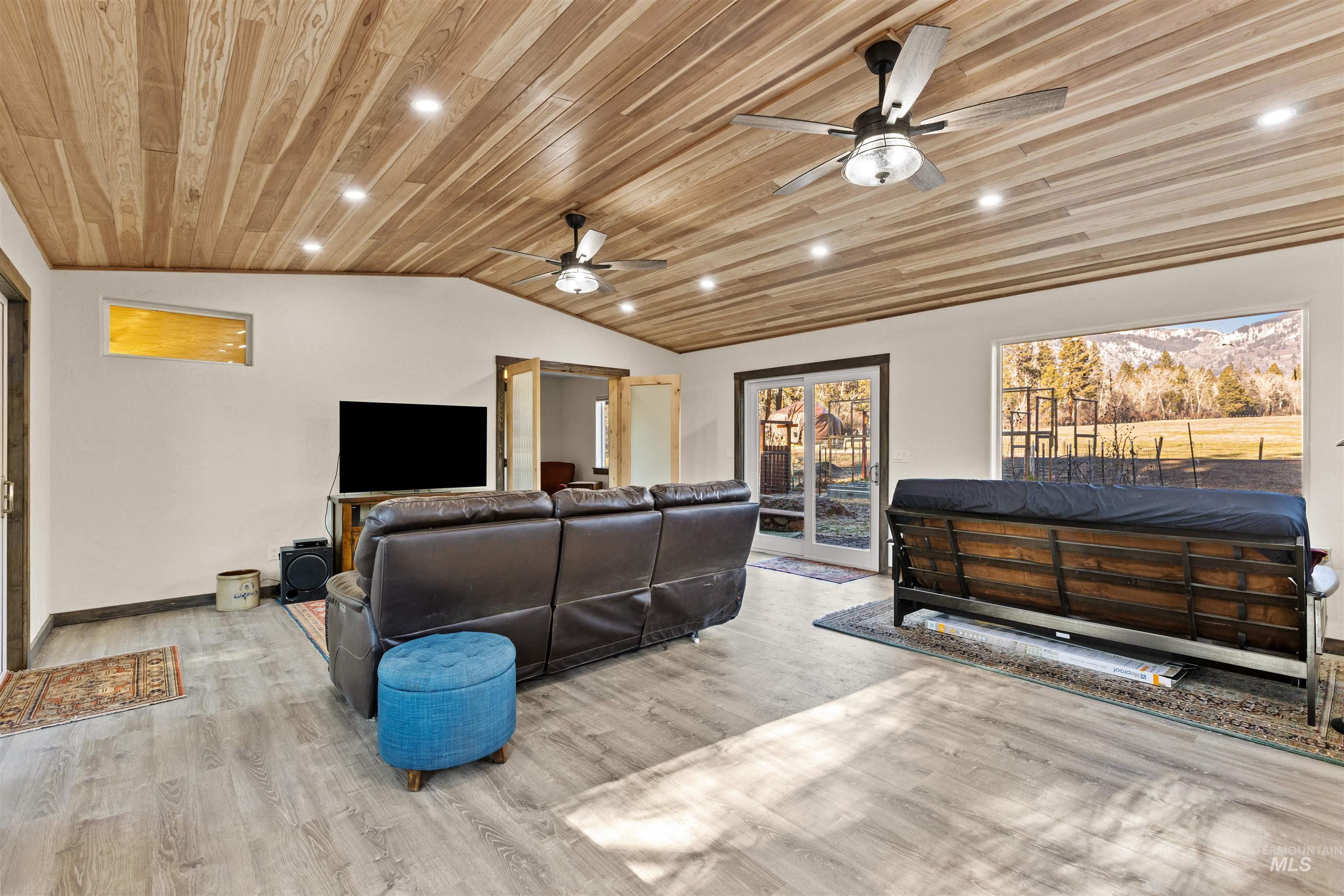 Sunroom with recessed lighting, lofted ceiling, wooden ceiling, wood finished floors, and ceiling fan